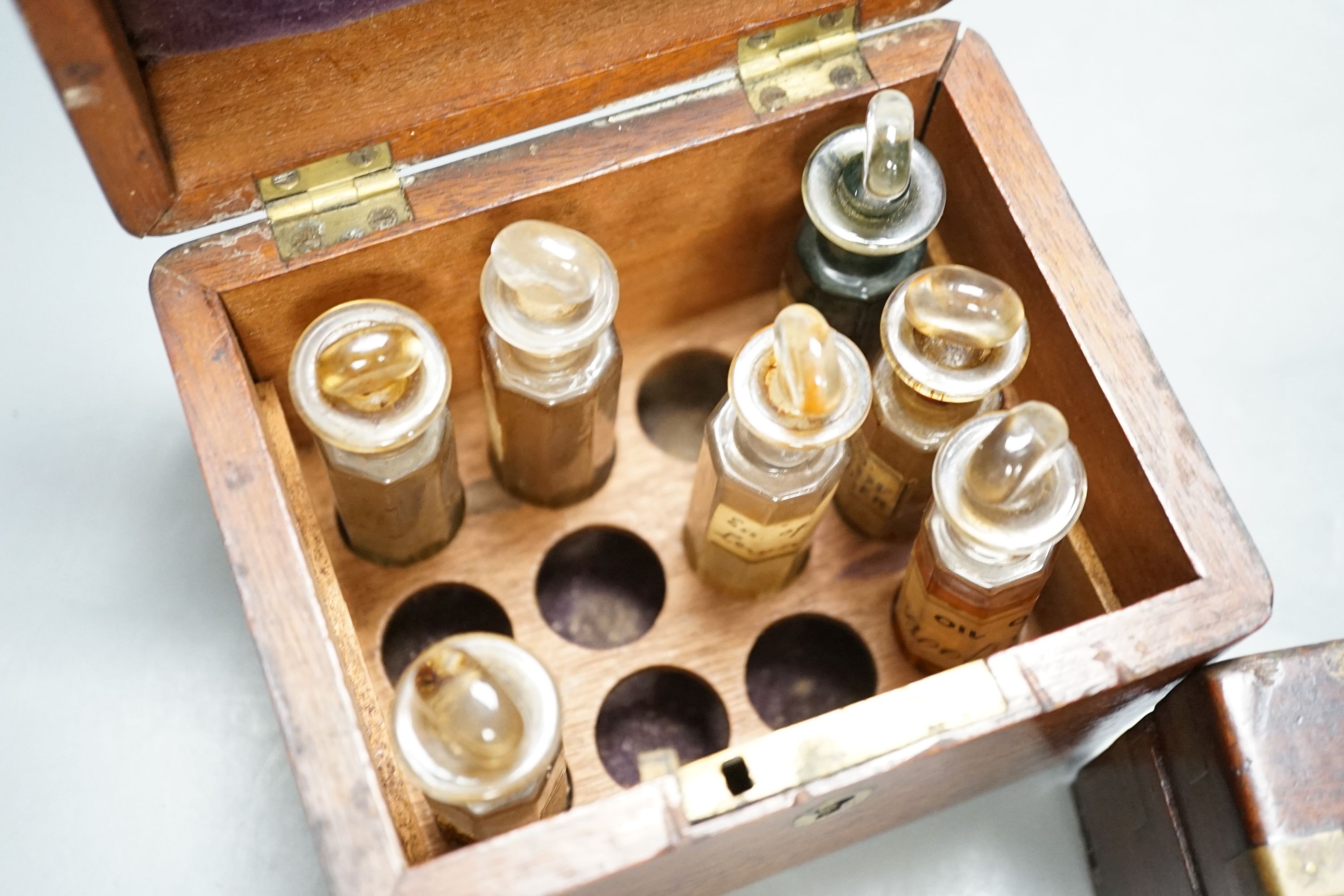 A Victorian mahogany medicine case, with bottles, 13cm. wide, a brass-mounted box and a rosewood veneered pen box